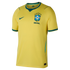 A yellow Nike Brazil national soccer team home jersey with green trim on the collar and cuffs. The shirt features a green Nike swoosh on the right chest and the official CBF crest on the left chest, topped by five stars and the word "BRASIL" below.