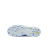 Bottom view of a Nike soccer cleat soleplate in white and light blue with blue studs and a yellow swoosh, set against a black background.