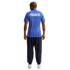 Back view of a person wearing a blue pinstriped "FRANCE" jersey, navy blue joggers, and white sneakers against a white background.