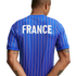 Rear view of a person wearing a blue jersey with thin red and white vertical stripes and "FRANCE" printed in large white letters on the upper back.