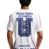 Rear view of a person wearing a white athletic shirt with "United States of America," a large blue star-patterned "U" graphic, and the date "04.05.1913" printed on the back.
