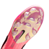 Bottom of a pink Nike soccer cleat featuring an iridescent soleplate, clear studs, a black Nike swoosh, and the text "Crafted for Brilliance" near the heel.