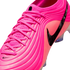 A vibrant pink Nike soccer cleat with a textured, ribbed upper, matching pink laces, and a prominent black swoosh logo on a plain white background.