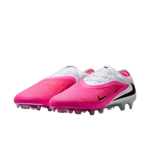 A pair of Nike Phantom Luna II soccer cleats in bright pink and white with black swooshes and clear studs against a white background.