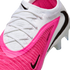 A close-up of a white and bright pink Nike soccer cleat with black swooshes, white laces, and textured Gripknit material.