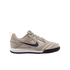 Side profile of a tan and beige Nike athletic shoe with a dark grey Swoosh logo, white midsole, and black outsole.