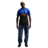 A man models a blue and black Inter Milan x Nike ACG jersey, blue patterned trousers, a grey beanie, and dark sneakers against a black background.