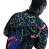 Rear view of a person with braided hair wearing a black jacket with a vibrant neon green, pink, and blue abstract skeletal pattern.