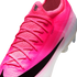 Close-up of a hot pink Nike soccer cleat featuring a black swoosh, pink laces, and the text "ATOMKNIT" on its textured upper.