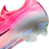 Close-up of a pink Nike Mercurial soccer cleat featuring a textured Flyknit upper, white heel, and an iridescent pearlescent sole plate.