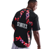 Rear view of a man wearing a black t-shirt with a large, colorful star-shaped graphic and the word "STATES" printed in bold white letters.