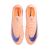 Top-down view of a pair of bright peach Nike Mercurial soccer cleats with large purple swooshes, displayed against a solid black background.