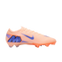 Profile view of a peach Nike Mercurial soccer cleat with a blue swoosh and large "M" logo on the heel, isolated against a black background.