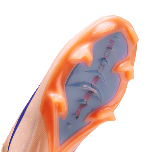 Close-up of the orange and iridescent sole of a Nike Air Zoom soccer cleat, showing the forefoot stud configuration against a black background.