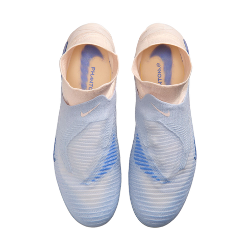 Top-down view of light blue and pale pink laceless Nike Phantom soccer cleats against a solid black background.