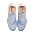 Top-down view of light blue and pale pink laceless Nike Phantom soccer cleats against a solid black background.