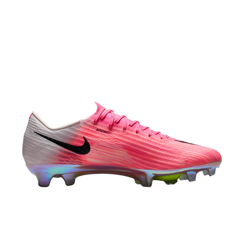 Side profile of a pink and white Nike soccer cleat with an iridescent sole plate and black swoosh.