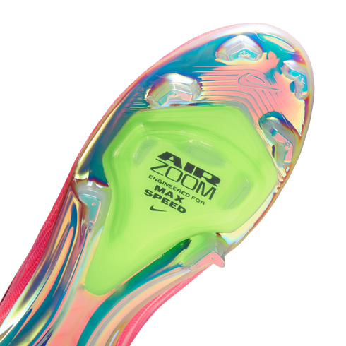 Close-up of an iridescent Nike soccer cleat soleplate with a neon green Air Zoom unit labeled "ENGINEERED FOR MAX SPEED."