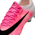 Close-up of a Nike Mercurial soccer cleat with a pink and white textured upper and a large black swoosh. The side features "FLYWEAVE ULTRA" text.