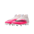 A pair of laceless Nike soccer cleats featuring a white-to-vibrant-pink gradient upper, black swooshes, and white studs on a plain background.