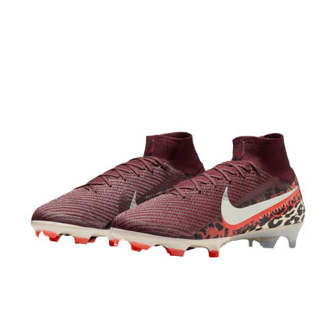 A pair of maroon Nike soccer cleats with a knitted texture and high-top collar, featuring a white swoosh and a bold animal print pattern on the heel, set against a solid black background.