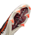 A close-up, angled view of the sole of a Nike soccer cleat. It features a cream-colored soleplate with bright orange bladed studs and a central red and black animal-print panel with "AIR ZOOM" written in silver.
