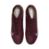 A top-down view of a pair of deep maroon Nike soccer cleats with silver swooshes and high-top ankle collars, set against a solid black background.