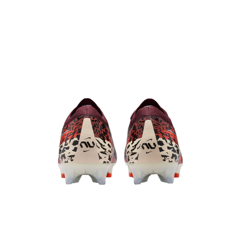 A rear-view of a pair of Nike soccer cleats against a black background. The shoes feature a maroon knit collar, a red and black leopard-print upper, and an off-white heel counter with a black "nu" logo. The translucent white studs have orange tips.
