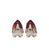 A rear-view of a pair of Nike soccer cleats against a black background. The shoes feature a maroon knit collar, a red and black leopard-print upper, and an off-white heel counter with a black "nu" logo. The translucent white studs have orange tips.