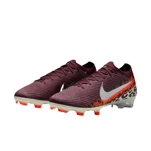 A pair of Nike Mercurial soccer cleats featuring a dark maroon knit upper that transitions into an orange and black leopard print pattern at the heel. A large white Nike swoosh is prominent on the side, and the cream-colored soleplate has bright orange st