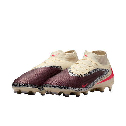 Nike United soccer cleats with maroon and cream uppers, black and white safari print accents, and pink Nike swooshes.