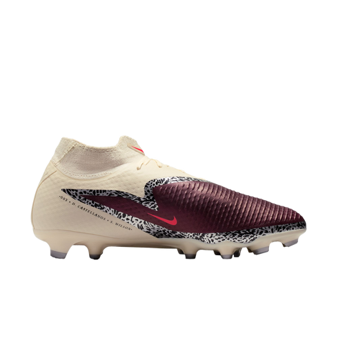 A cream and maroon Nike soccer cleat with black-and-white safari-print accents and a red Nike logo. The side features text: "003 x D. CASTELLANOS + S. WILSON".