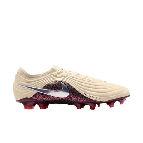 A side-profile view of a Nike soccer cleat featuring a cream-colored ridged upper, a large silver Swoosh over a maroon and black patterned midsection, and a maroon soleplate with red studs against a black background.