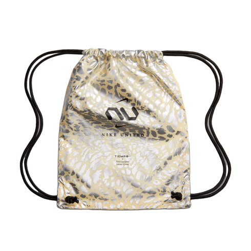 A drawstring bag with a pale yellow and metallic silver animal-print pattern, featuring a black "NU" logo, the text "NIKE UNITED," and names of athletes below it, set against a black background.