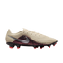 Side profile of a Nike United soccer cleat featuring a tan ridged upper, silver swoosh, and red-and-black patterned lower section against a black background.