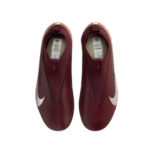 A top-down view of a pair of laceless, maroon Nike soccer cleats against a solid black background. The shoes feature large white Nike swooshes on the sides and a textured upper.