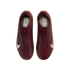 A top-down view of a pair of laceless, maroon Nike soccer cleats against a solid black background. The shoes feature large white Nike swooshes on the sides and a textured upper.
