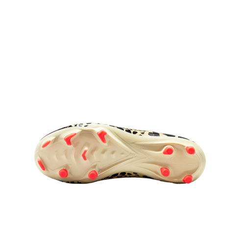 A bottom-up view of a soccer cleat with an off-white outsole and bright orange studs. The shoe's upper, visible around the edges, features a leopard print pattern.