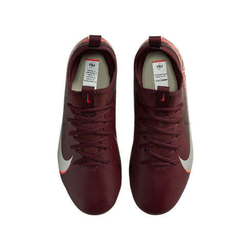 A top-down view of a pair of burgundy Nike soccer cleats against a black background. The cleats feature maroon laces and a white Nike swoosh with a red outline on the sides.
