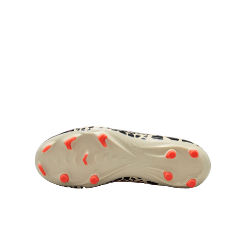 A bottom view of an off-white soccer cleat with bright orange studs and a black-and-white leopard print upper, centered against a solid black background.