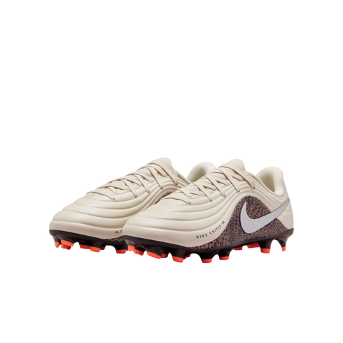 A pair of off-white Nike soccer cleats featuring a leopard print design on the heel and bright orange studs, set against a solid black background.