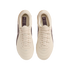 A top-down view of a pair of cream-colored Nike Tiempo soccer cleats centered against a black background. The shoes feature matching cream laces and a quilted, textured upper. Inside each shoe, a dark purple insole displays the "Tiempo" name and a list of