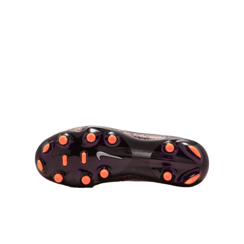 The glossy black outsole of a Nike soccer cleat featuring bright orange studs and a white Nike swoosh in the center. A leopard-print pattern is visible on the edges of the shoe's upper against a solid black background.