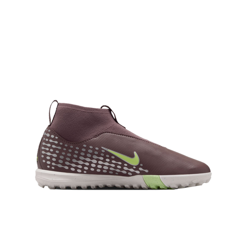Side view of a mauve Nike soccer turf shoe with light green accents and a white speckled sole, isolated on a black background.