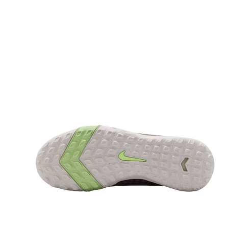 White textured outsole of a Nike turf shoe with a lime green chevron on the forefoot and a lime green swoosh in the center.