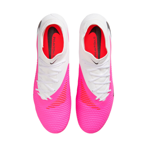 Top-down view of a pair of Nike Phantom soccer cleats featuring a white upper, a bright pink textured forefoot, and white laces against a plain white background.