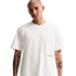 A man with a shaved head and tattooed arms wears a white Nike Football t-shirt against a black background.