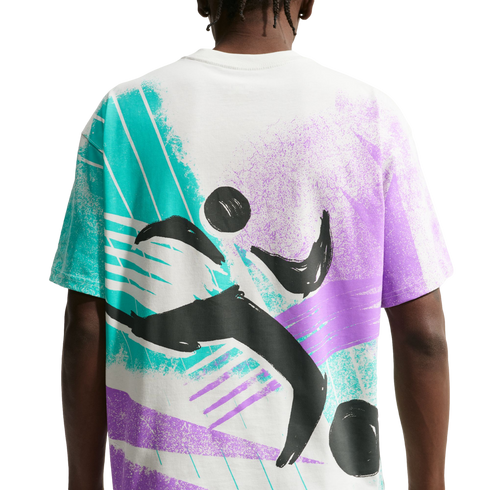Rear view of a white t-shirt featuring a large, abstract graphic in teal, purple, and black. The 90s-inspired design includes bold, energetic brushstrokes and stylized black shapes depicting a figure in motion against a splattered background.