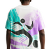 Rear view of a white t-shirt featuring a large, abstract graphic in teal, purple, and black. The 90s-inspired design includes bold, energetic brushstrokes and stylized black shapes depicting a figure in motion against a splattered background.