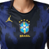 Close-up of a dark blue Brazil football jersey featuring vertical stripes, the CBF crest with five stars, and a yellow Jordan Jumpman logo.